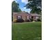 Charming brick home with well-manicured landscaping and inviting curb appeal at 715 Gentry Pl, Charlotte, NC 28210