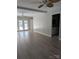 The living room offers wood floors, neutral paint, and a ceiling fan, plus backyard access from the French doors at 715 Gentry Pl, Charlotte, NC 28210