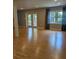 Living room with French doors leading to a sunroom and large windows with curtains at 715 Gentry Pl, Charlotte, NC 28210