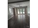 Spacious living room boasts wood floors, neutral paint, a ceiling fan and plenty of natural light from the French doors at 715 Gentry Pl, Charlotte, NC 28210