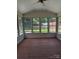 Sunroom featuring wood flooring and windows offering views of the backyard at 715 Gentry Pl, Charlotte, NC 28210