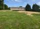 Large, grassy backyard featuring a wooden deck and mature trees providing ample space at 7308 Pleasant Hill Church Rd, Marshville, NC 28103