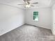 Neutral bedroom with carpet, ceiling fan, and a window offering outdoor views at 7308 Pleasant Hill Church Rd, Marshville, NC 28103