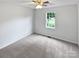 Simple bedroom featuring neutral carpet, white walls, ceiling fan and natural light from the window at 7308 Pleasant Hill Church Rd, Marshville, NC 28103