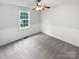 Bright bedroom with a window and paneled wainscoting featuring neutral paint and carpet at 7308 Pleasant Hill Church Rd, Marshville, NC 28103