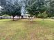 Inviting single-story home with a quaint front porch and mature shade trees at 7308 Pleasant Hill Church Rd, Marshville, NC 28103