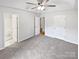 Spacious primary bedroom featuring carpet, ceiling fan, and ensuite bathroom at 7308 Pleasant Hill Church Rd, Marshville, NC 28103