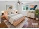 Comfortable bedroom with a light wood bed frame, soft rug, and decorative art at 7308 Pleasant Hill Church Rd, Marshville, NC 28103