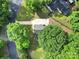 An aerial view of a home featuring a long driveway, mature trees, and a lush green lawn at 8514 Timber Crest Cir, Charlotte, NC 28226