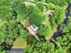 An aerial view of a home featuring a long driveway, mature trees, and a lush green lawn at 8514 Timber Crest Cir, Charlotte, NC 28226