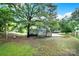 View of the home with large backyard, mature trees and wooden fence at 8514 Timber Crest Cir, Charlotte, NC 28226