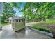 This backyard features green grass, a wooden fence, shed, and a metal raised flower bed at 8514 Timber Crest Cir, Charlotte, NC 28226