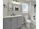 This bathroom features gray walls, gray tiling, gray vanity and black fixtures at 8514 Timber Crest Cir, Charlotte, NC 28226
