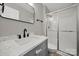 Modern bathroom features stylish vanity with marble countertop and a glass-enclosed shower at 8514 Timber Crest Cir, Charlotte, NC 28226