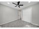 This bedroom features gray walls, gray carpeting, a ceiling fan and a closet at 8514 Timber Crest Cir, Charlotte, NC 28226