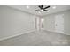 This bedroom features gray walls, gray carpeting, a ceiling fan and access to a bathroom at 8514 Timber Crest Cir, Charlotte, NC 28226