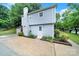 A view of the side of the house with a brick chimney and a paved driveway at 8514 Timber Crest Cir, Charlotte, NC 28226