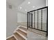 View of foyer area that has hardwood flooring and a metal railing on the staircase at 8514 Timber Crest Cir, Charlotte, NC 28226