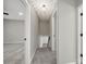 The hallway features gray walls and carpet with access to a basement at 8514 Timber Crest Cir, Charlotte, NC 28226