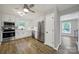 Well-lit kitchen features white cabinets, stainless steel appliances, and durable hardwood floors at 8514 Timber Crest Cir, Charlotte, NC 28226