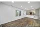 Bright living room area with hardwood floors and open access to the kitchen at 8514 Timber Crest Cir, Charlotte, NC 28226