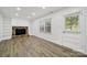Cozy living room features hardwood floors and a brick fireplace with built-in shelving at 8514 Timber Crest Cir, Charlotte, NC 28226