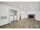 Inviting living space with laundry area, brick fireplace and a door to the backyard at 8514 Timber Crest Cir, Charlotte, NC 28226