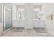 Bathroom featuring double vanities, tiled floors, and a glass-enclosed shower stall at 8840 Mullis Forest Ct, Mint Hill, NC 28227