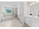Bright bathroom with double vanity, soaking tub, and a glass-enclosed shower at 8840 Mullis Forest Ct, Mint Hill, NC 28227