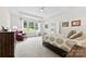 Bright bedroom with a large window, tray ceiling, and a comfortable sitting area at 8840 Mullis Forest Ct, Mint Hill, NC 28227