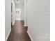 Bright hallway with hardwood flooring and neutral walls, leading to other rooms at 8840 Mullis Forest Ct, Mint Hill, NC 28227