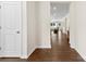 Inviting hallway with rich wood floors offers a glimpse into the brightly lit living space beyond at 8840 Mullis Forest Ct, Mint Hill, NC 28227