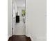 Hallway view with hardwood and carpet, leading to a bedroom with natural light at 8840 Mullis Forest Ct, Mint Hill, NC 28227