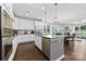 Open kitchen with stainless steel appliances, granite countertops, and white cabinets at 8840 Mullis Forest Ct, Mint Hill, NC 28227