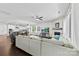 Open living area featuring a fireplace, large windows, and seamless flow into a modern white kitchen at 8840 Mullis Forest Ct, Mint Hill, NC 28227