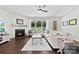 Inviting living room featuring a fireplace, large sectional sofa, and lots of windows at 8840 Mullis Forest Ct, Mint Hill, NC 28227