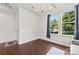 Bright living room with dark wood floors, large windows, and modern lighting fixtures for a welcoming space at 8840 Mullis Forest Ct, Mint Hill, NC 28227