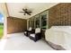 Comfortable outdoor seating and a grill under a covered patio with ceiling fan, perfect for outdoor entertaining at 8840 Mullis Forest Ct, Mint Hill, NC 28227