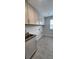 Well-lit laundry room featuring ample cabinet storage above the front load washer and dryer hookups at 885 Regulus Ct # 42, York, SC 29745