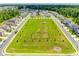 Community aerial view of a green neighborhood park with playground surrounded by sidewalks and beautifully built homes at 922 Bunker Trce, Rock Hill, SC 29730