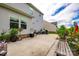 Spacious backyard with a concrete patio, vibrant potted plants, and a well-maintained lawn at 922 Bunker Trce, Rock Hill, SC 29730