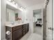 Bright bathroom with double sink vanity, flowers and an open doorway to the bedroom at 922 Bunker Trce, Rock Hill, SC 29730