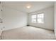 Sunlit bedroom with large windows showcasing the neighborhood view and plush carpeting at 922 Bunker Trce, Rock Hill, SC 29730