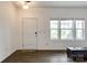 Bright entryway with hardwood floors, white door, and natural light from the adjacent windows at 922 Bunker Trce, Rock Hill, SC 29730