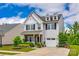 Charming two-story home with a well-manicured lawn and inviting front porch at 922 Bunker Trce, Rock Hill, SC 29730