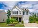 Charming two-story home with white siding, black shutters, covered porch, and a well-manicured lawn at 922 Bunker Trce, Rock Hill, SC 29730