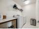Functional laundry room with modern washer, dryer, and overhead storage providing convenience at 922 Bunker Trce, Rock Hill, SC 29730