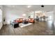 Spacious open-concept living room with hardwood floors, modern furniture, and seamless flow to the kitchen at 922 Bunker Trce, Rock Hill, SC 29730