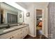 Bathroom featuring granite countertops, white cabinets, and a view into the bedroom at 9239 N Vicksburg Park Ct, Charlotte, NC 28210