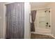 Bathroom featuring a tub and shower combination with a patterned gray shower curtain at 9239 N Vicksburg Park Ct, Charlotte, NC 28210